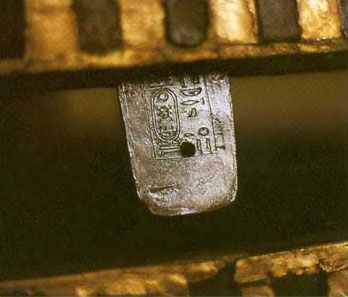 An inscribed silver tenon, one of ten, attaching the lid and base of the second coffin